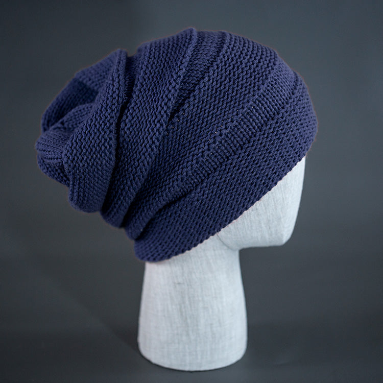 A navy blue colored, alternating rib knit blank beanie with a pre scrunched back.  Designed by Blvnk Headwear.