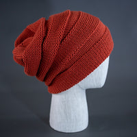 A rust colored, alternating rib knit blank beanie with a pre scrunched back.  Designed by Blvnk Headwear.