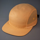 A Biscuit colored, Cotton Twill/Mesh, Blank 5 Panel Camp Trucker Hat With a Flat Bill, & Woven Nylon Strapback.  Designed by Blvnk Headwear.